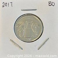 Coin in holder showing reverse hockey design
