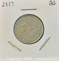 Coin in holder, year mark visible BU notation