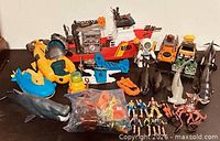 Overall lot showing main boat, submarine, animals, vehicles, figures, accessory bag