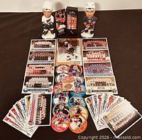 Full lot with bobbleheads, mini stick, trading cards and discs displayed