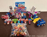 Overall lot showing boxed sets, loose vehicles, bag of figures