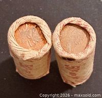 Two upright paper-wrapped rolls showing coin ends
