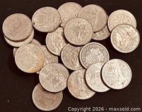 Pile of Canadian $1 coins displaying assorted reverse designs