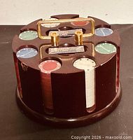 Front angled view of wooden carousel loaded with chips and showing brass handle