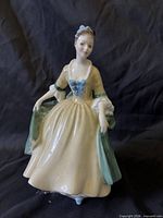 Front view of Royal Doulton Elegance figurine showing full gown and facial detail