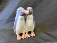 Front view of Royal Copenhagen two-penguin porcelain figurine