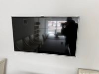 Front view of 50-inch LG TV powered off, wall-mounted