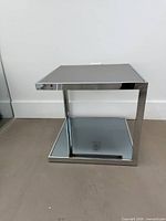 full view showing chrome frame and mirrored glass shelves