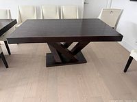 Overall view of dining table front angle showing top surface and base