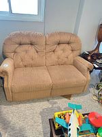 Front view of tan chenille tufted loveseat showing two cushions and backrest