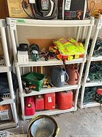 full view of beige plastic 4-tier shelf loaded with various items
