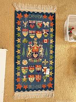 Full view of blue heraldic wool runner with fringe