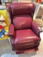 Front view of burgundy leather wingback recliner with footrest retracted