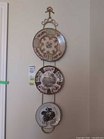 Full view of three plates mounted in wall rack