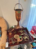 Overall lot showing urn, tray, and brass accessories