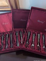 Three presentation boxes with forks and spreaders visible