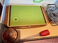 Overall lot showing warmer base, acrylic insert in chrome frame, baster, wooden lid