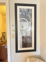 Full view of framed abstract print hanging on wall