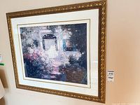 Full view of framed garden landscape print in ornate gold frame on wall