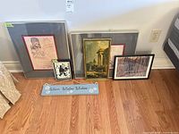 Group shot showing all four framed prints and holiday sign on floor against wall