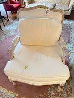 Front view showing overall chair, upholstery color and stains