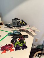 Multiple GI Joe vehicles and accessories on table