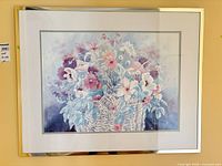 Framed signed floral print showing basket of flowers, matting and metal frame