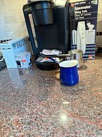 Full lot showing Keurig brewer, Brita box, boxed Black & Decker knife, pitchers and scoop