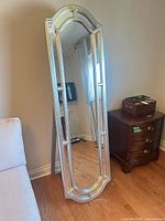 Full view of tall silver framed floor mirror with easel back