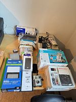 Overview of all boxed and loose electronics on table