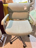 Front view of office chair showing upholstery and caster base