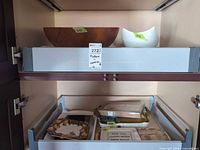 Wood bowl and white ceramic bowl on upper pull-out shelf