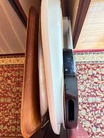 Side view of stacked trays showing wood, ceramic and lacquer pieces