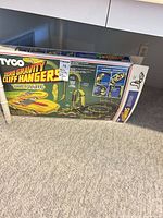 Front of Tyco Zero Gravity Cliff Hangers Nite-Glow box under table