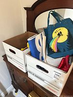 Two storage boxes containing ET tote bag and assorted toys and fabrics