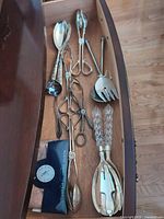 Drawer view showing entire set of serving pieces and polishing cloth