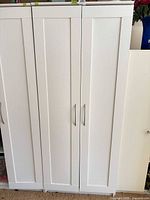 Front view of closed white two-door cabinet