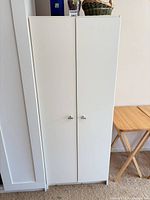 full view closed cabinet front showing doors and handles