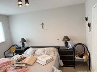 Both accent chairs flanking bed