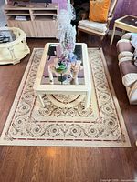 Full view of rug under coffee table showing size, pattern and colors