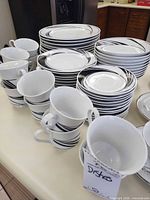 Stacks of dinner plates, salad plates, cups and saucers in swirl pattern