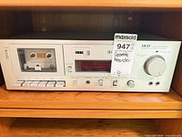 Front view of Akai CS-M02 cassette deck on shelf showing entire unit