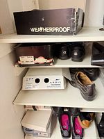 Aquatalia suede boots and Hush Puppies boots on shelving