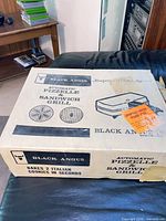 Top of original Black Angus Automatic Pizzelle & Sandwich Grill box