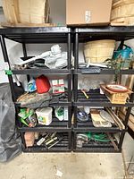 Full view of both black plastic shelving units side by side with items on shelves