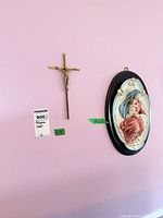 Brass crucifix and oval Madonna & Child plaque on wall