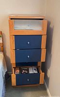 Front view of tallboy dresser with drawers partially open