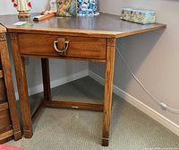 full view of corner desk showing legs and drawer