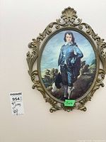 Oval metal frame with boy portrait print