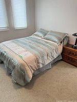 Full bed with mattress, comforter, pillow shams, dust ruffle